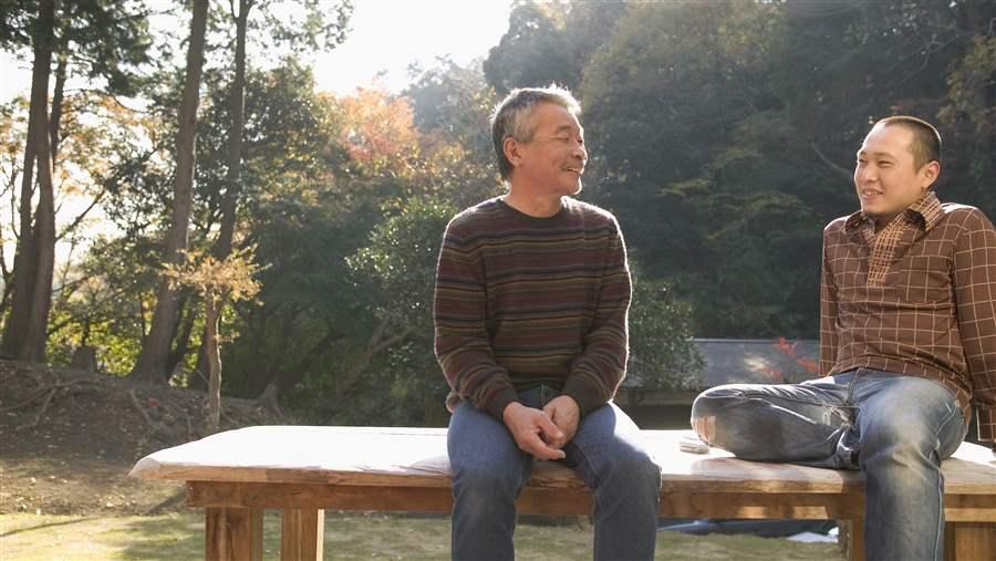 Father and son sitting on bench