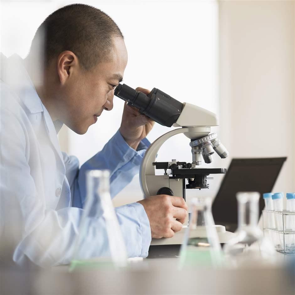 A scientist using a microscope in a laboratory 